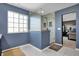 Bright bathroom featuring a glass shower, white marble floors, and blue walls at 13836 Fieldcrest Dr, McCordsville, IN 46055