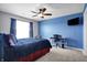 Bright bedroom featuring a desk area and ceiling fan at 13836 Fieldcrest Dr, McCordsville, IN 46055