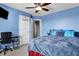 Cozy bedroom featuring a desk, ceiling fan, and warm natural light at 13836 Fieldcrest Dr, McCordsville, IN 46055