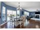 Sunlit dining area boasts a stylish chandelier and view of the pool and backyard at 13836 Fieldcrest Dr, McCordsville, IN 46055