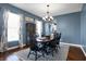 Bright dining room with large windows, chandelier, and views into the kitchen at 13836 Fieldcrest Dr, McCordsville, IN 46055