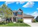 Beautifully landscaped two-story home with a brick facade, manicured lawn, and inviting curb appeal at 13836 Fieldcrest Dr, McCordsville, IN 46055