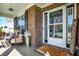 Inviting front porch with stylish seating, decorative rug, and a welcoming entrance at 13836 Fieldcrest Dr, McCordsville, IN 46055