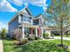 Inviting two-story home with lush lawn, manicured landscaping, and a charming front porch at 13836 Fieldcrest Dr, McCordsville, IN 46055