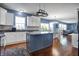 Modern kitchen with a large island and views into the dining and living spaces at 13836 Fieldcrest Dr, McCordsville, IN 46055