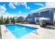 The backyard oasis includes a sparkling pool, lounge area with fire pit, and an outdoor dining area for entertaining at 13836 Fieldcrest Dr, McCordsville, IN 46055