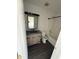 Updated bathroom with wood-look vanity, shower and modern fixtures at 1539 Egret Ln, Greenwood, IN 46143