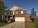 Charming two-story brick home featuring an attached two-car garage and well-maintained front yard at 1539 Egret Ln, Greenwood, IN 46143