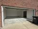 Attached two-car garage featuring concrete flooring, bright lighting, and interior access door at 1539 Egret Ln, Greenwood, IN 46143