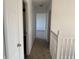 Bright hallway with neutral carpet and white walls leads to bedrooms at 1539 Egret Ln, Greenwood, IN 46143