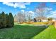 View of a spacious backyard featuring lush green lawn and mature trees at 16 Cattail Ln, Brownsburg, IN 46112