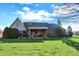 Lovely backyard featuring lush lawn, mature trees, with a covered patio on the brick home at 16 Cattail Ln, Brownsburg, IN 46112