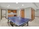 Basement recreation room features a ping pong table, built-in bar, cabinets, and sink at 16 Cattail Ln, Brownsburg, IN 46112