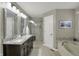 Bathroom with a dual sink vanity, granite countertop, glass enclosed shower and a soaker tub at 16 Cattail Ln, Brownsburg, IN 46112