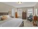 Bedroom with neutral colors, an upholstered armchair, and bright natural light from two windows at 16 Cattail Ln, Brownsburg, IN 46112