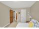 Bedroom with neutral walls and carpet flooring with a view into an adjacent room at 16 Cattail Ln, Brownsburg, IN 46112