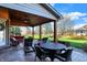 Covered patio with outdoor seating and a view of the lush green backyard at 16 Cattail Ln, Brownsburg, IN 46112