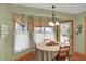 Bright breakfast nook with decorative curtains, natural light, and hardwood floors at 16 Cattail Ln, Brownsburg, IN 46112