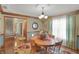 Formal dining room featuring wainscoting, chandelier, and wood table at 16 Cattail Ln, Brownsburg, IN 46112