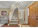 Inviting foyer featuring hardwood floors, a staircase, and a chandelier at 16 Cattail Ln, Brownsburg, IN 46112