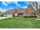 Charming single-Gathering home featuring a brick exterior, manicured lawn, and attached two car garage at 16 Cattail Ln, Brownsburg, IN 46112