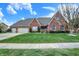Lovely single-Gathering home featuring a brick exterior, manicured lawn, two car garage, and blue skies at 16 Cattail Ln, Brownsburg, IN 46112