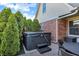 Backyard with a hot tub, mature trees, and outdoor furniture at 16 Cattail Ln, Brownsburg, IN 46112