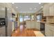 Bright kitchen with stainless appliances, granite countertops, and hardwood flooring at 16 Cattail Ln, Brownsburg, IN 46112