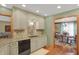Charming kitchen features granite counters, tile backsplash, stainless steel sink, and custom cabinetry at 16 Cattail Ln, Brownsburg, IN 46112