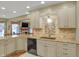 Well-lit kitchen features granite countertops, tile backsplash, stainless steel sink, and stylish cabinets at 16 Cattail Ln, Brownsburg, IN 46112