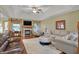 Spacious living room boasts a fireplace, fan, and tray ceiling at 16 Cattail Ln, Brownsburg, IN 46112