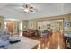 Open-concept living room with seating, hardwood floors, and kitchen view at 16 Cattail Ln, Brownsburg, IN 46112