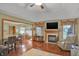 Open-concept living area showcases fireplace, hardwood floors, and nearby kitchen at 16 Cattail Ln, Brownsburg, IN 46112