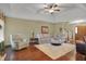 Comfortable living room with large couch, ottoman, and hardwood floors at 16 Cattail Ln, Brownsburg, IN 46112