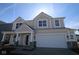 Beautiful new construction home with a covered front porch and a two-car garage at 16830 Silo Meadows Dr, Noblesville, IN 46060