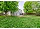 Spacious backyard with green grass and mature trees, perfect for outdoor activities at 18980 Bladed Mills Dr, Noblesville, IN 46062