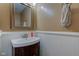 Half bathroom with decorative mirror, single sink, wainscotting and neutral walls at 18980 Bladed Mills Dr, Noblesville, IN 46062