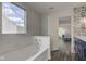 Clean bathroom with a tiled bathtub and partial view of an updated vanity at 18980 Bladed Mills Dr, Noblesville, IN 46062