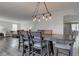 An open dining room features a decorative lighting fixture and seating for six at 18980 Bladed Mills Dr, Noblesville, IN 46062