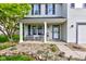 Inviting covered front porch has a seating area and a view of the home's well-kept yard at 18980 Bladed Mills Dr, Noblesville, IN 46062