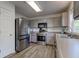 Well-lit kitchen features stainless steel appliances, light grey cabinetry and modern flooring at 18980 Bladed Mills Dr, Noblesville, IN 46062