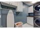 Well-equipped laundry space with washer, dryer, ironing board, and built-in cabinets at 18980 Bladed Mills Dr, Noblesville, IN 46062