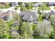 Aerial view showcases a large home with a manicured lawn, mature trees, and a well-maintained landscape at 19311 Morrison Way, Noblesville, IN 46060