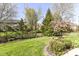 Landscaped backyard featuring a manicured lawn and mature trees for outdoor enjoyment at 19311 Morrison Way, Noblesville, IN 46060