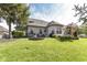 Expansive backyard features lush lawn, stone flowerbeds, mature trees, and a patio with seating at 19311 Morrison Way, Noblesville, IN 46060