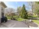 Beautiful backyard features a lush lawn, mature trees, and a charming white picket fence at 19311 Morrison Way, Noblesville, IN 46060