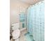 Clean bathroom featuring a toilet, decorative blue accents, and a shower with a stylish curtain at 19311 Morrison Way, Noblesville, IN 46060