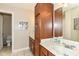 Well-lit bathroom featuring double sinks, wooden cabinetry, and a large mirror for a functional space at 19311 Morrison Way, Noblesville, IN 46060