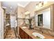 Bathroom with double sinks, granite countertops, and custom tile at 19311 Morrison Way, Noblesville, IN 46060
