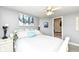 Inviting bedroom with a queen bed, a ceiling fan, neutral walls, carpet, and access to the walk-in closet at 19311 Morrison Way, Noblesville, IN 46060